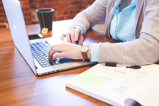 A person typing on a laptop