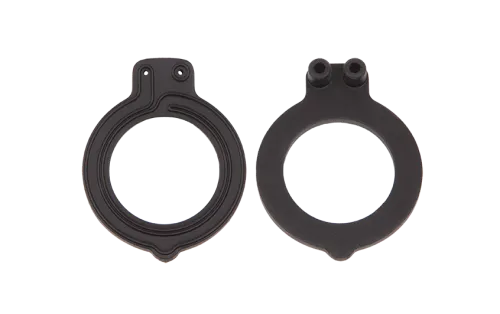 A photograph of two black circular rubber gaskets. One is shown from the front, and one is shown from the back.