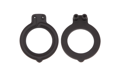 A photograph of two black circular rubber gaskets. One is shown from the front, and one is shown from the back.